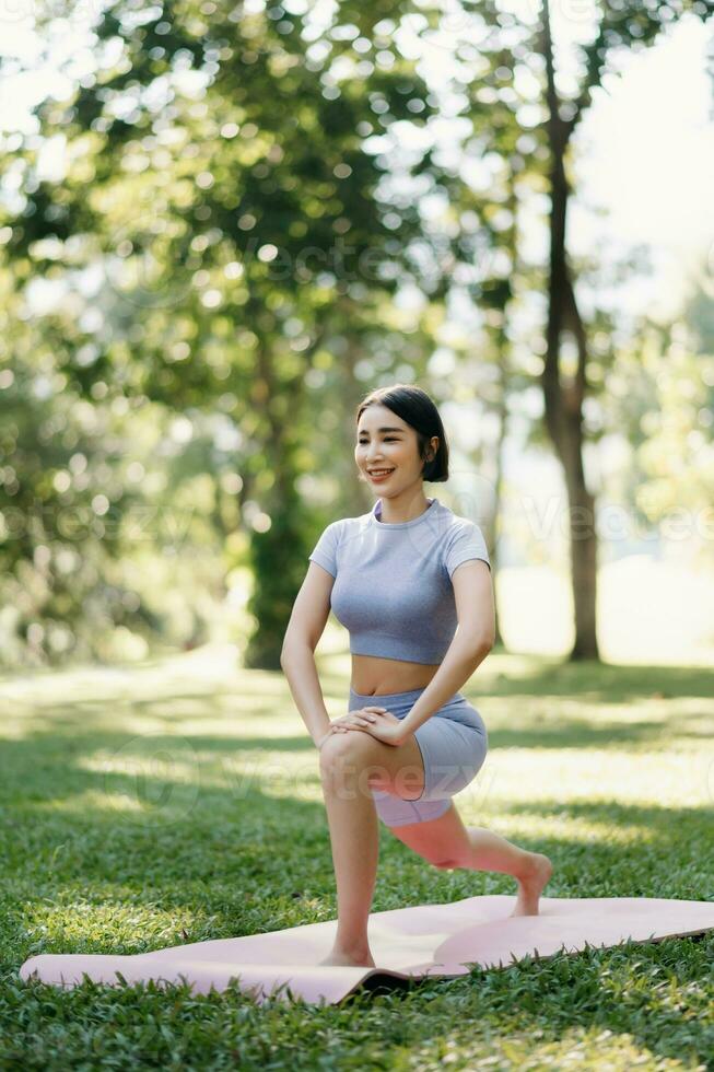 Portrait of young woman practicing yoga in garden.female happiness.  in the park blurred background. photo