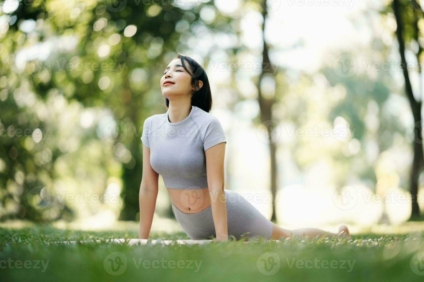 Portrait of young woman practicing yoga in garden.female happiness.  in the park blurred background. photo