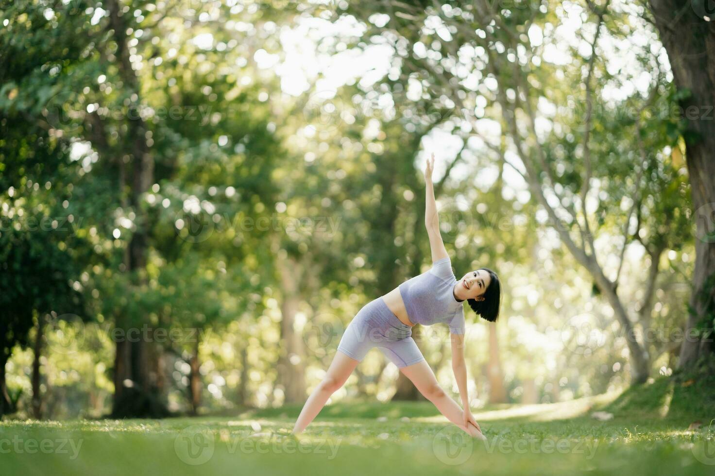 Portrait of young woman practicing yoga in garden.female happiness.  in the park blurred background. photo