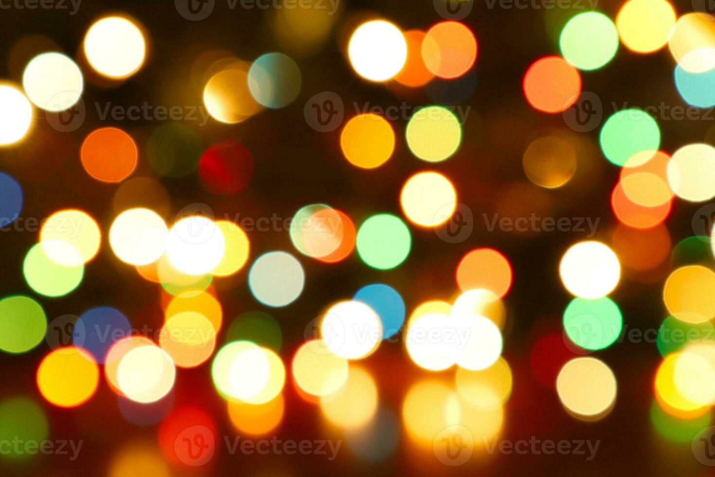 Colorful blurred bokeh lights. Abstract colorful Christmas tree garland lights background. Festive backdrop with copy space. Holiday illumination and decoration concept. Defocused image. photo
