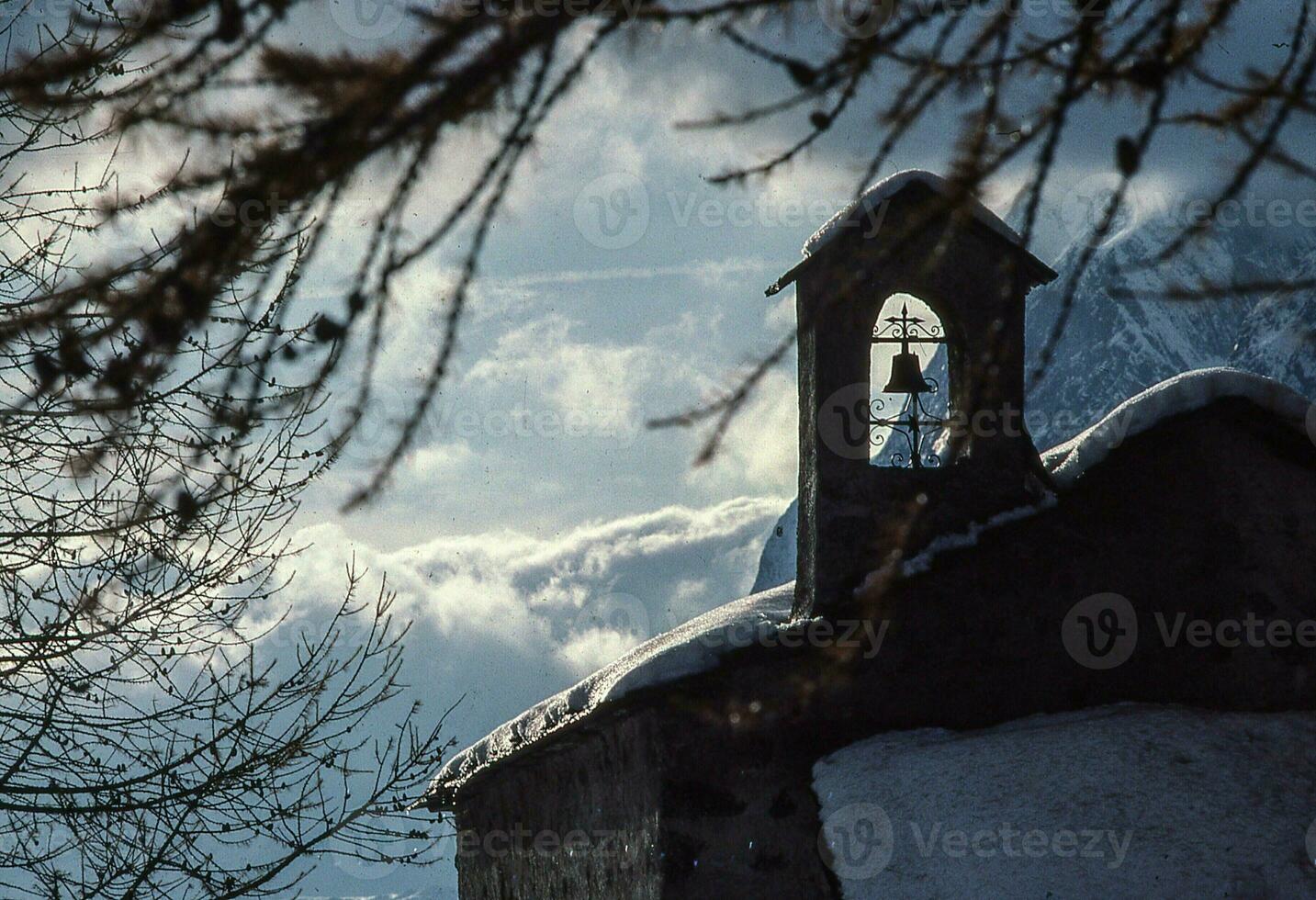 a church in the snow with a bell tower photo