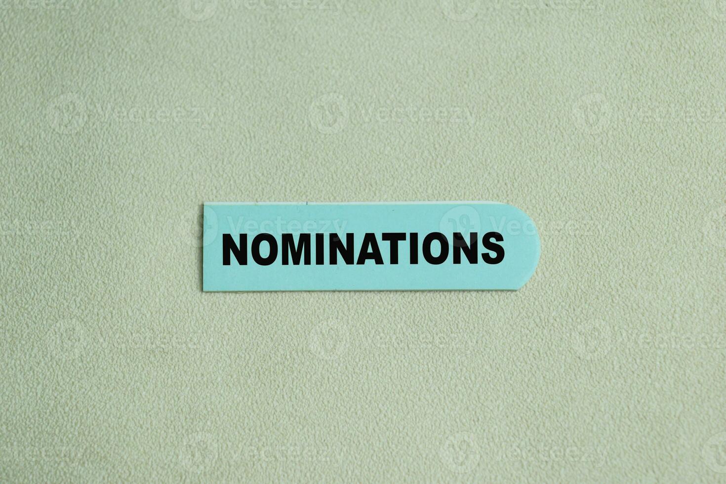 Concept of Nominations write on sticky notes isolated on Wooden Table. photo