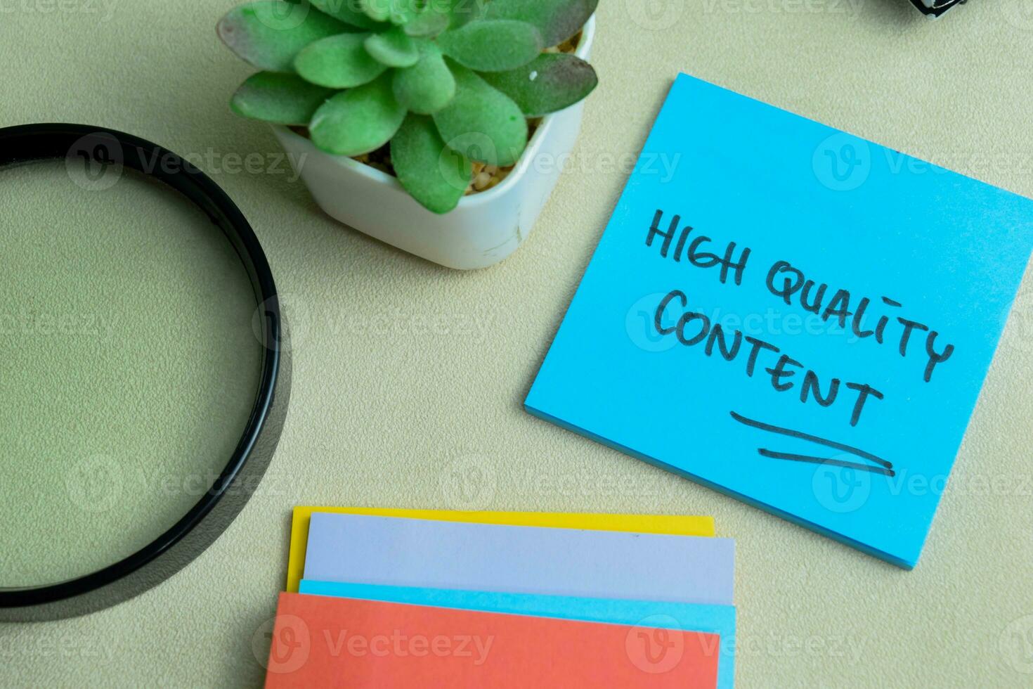 Concept of High Quality Content write on sticky notes isolated on Wooden Table. photo