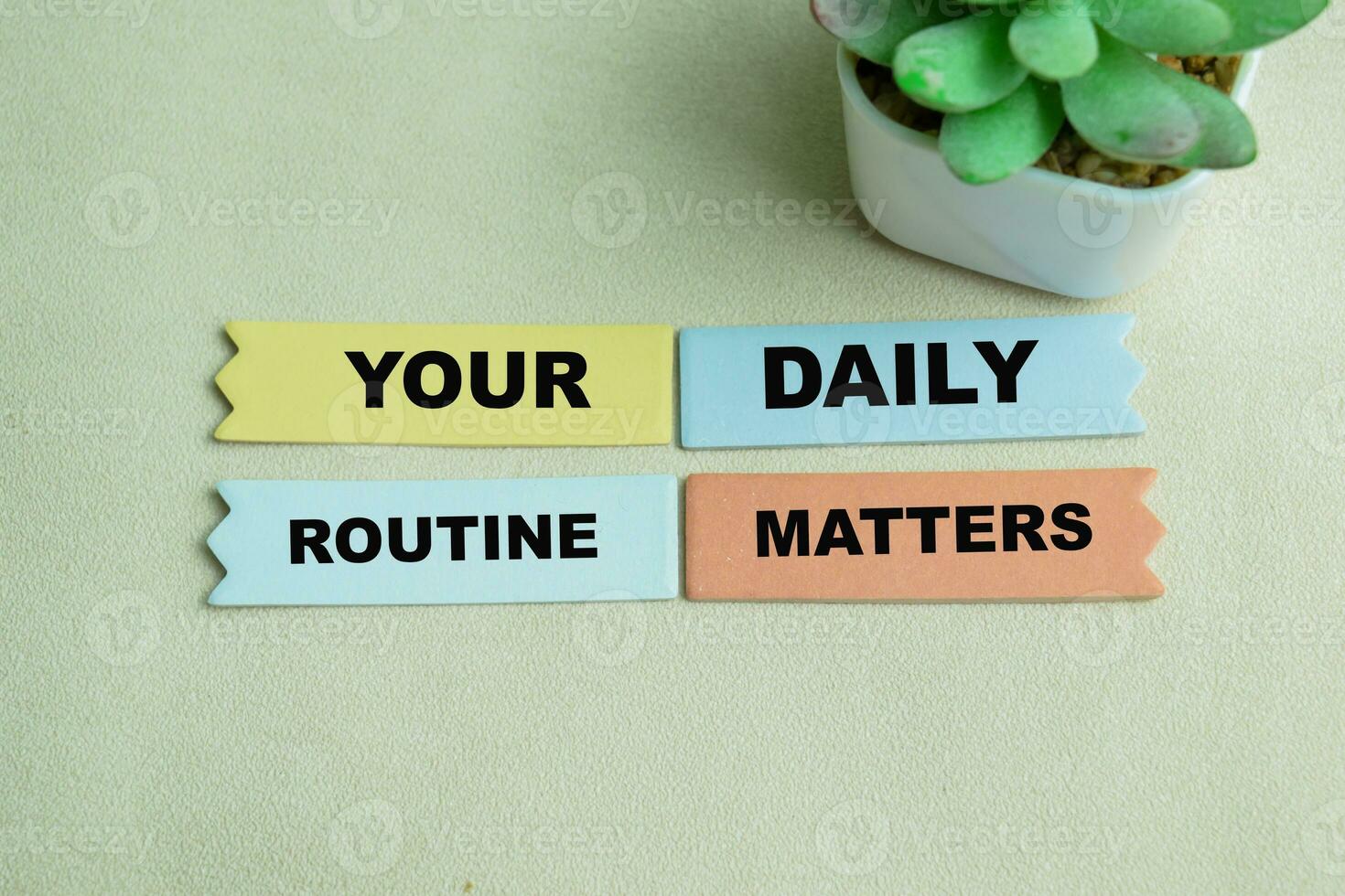 Concept of Your Daily Routine Matters write on sticky notes isolated on Wooden Table. photo