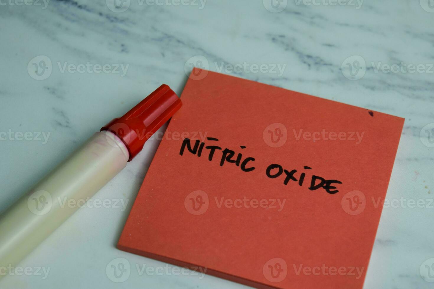 Concept of Nitric Oxide write on sticky notes isolated on Wooden Table. photo