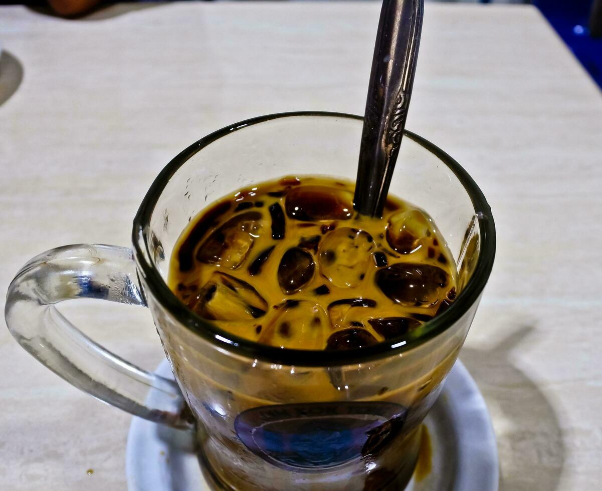 close-up view of a glass of iced cappuccino coffee photo