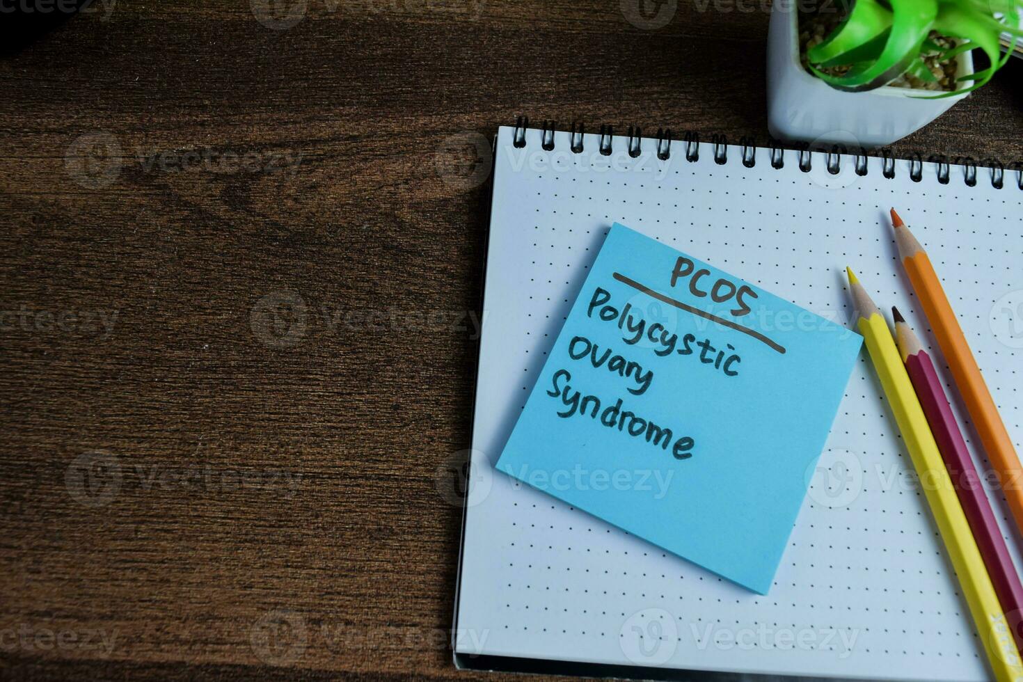 Concept of PCOS - Polycystic Ovary Syndrome write on sticky notes isolated on Wooden Table. photo