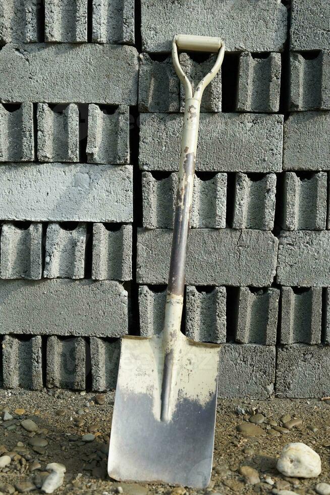 rusty shovel abandoned in construction area photo