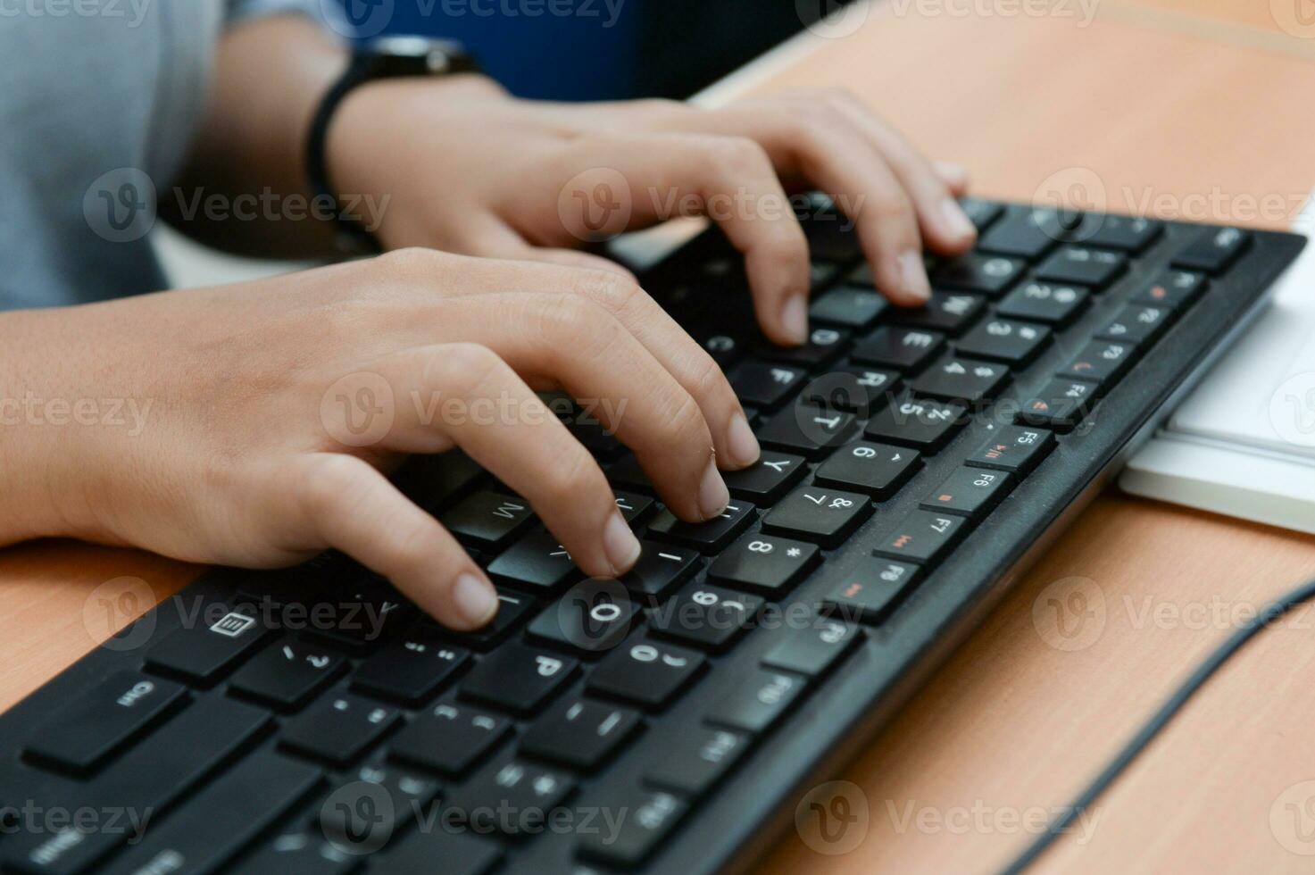 Business man using laptop computer. Male hand typing on laptop keyboard. Selective focus photo