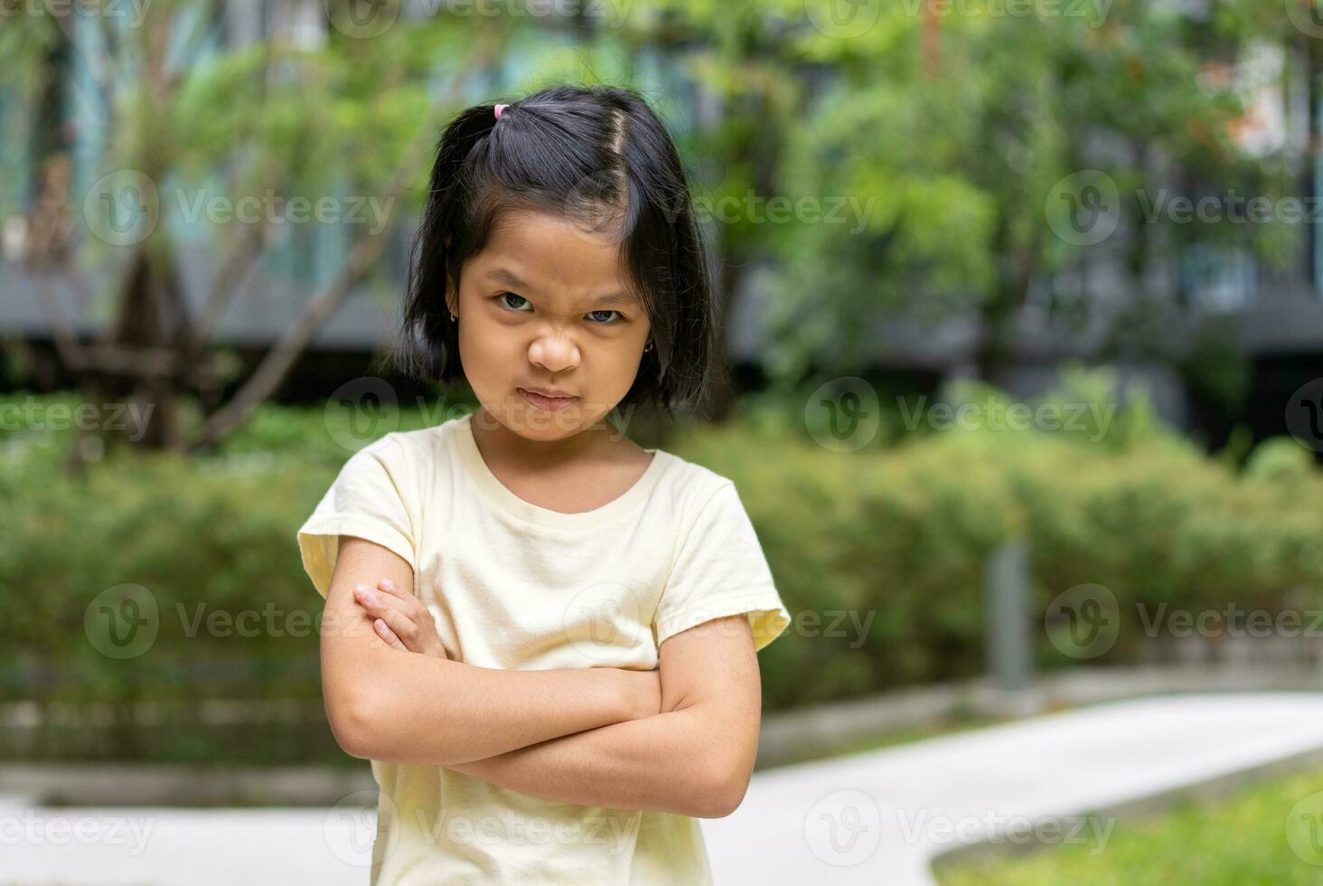 Portrait of an Asian angry and sad little girl. The emotion of a child when tantrum and mad, expression of grumpy emotion. Kid emotional control, attention deficit hyperactivity disorder concept ADHD photo
