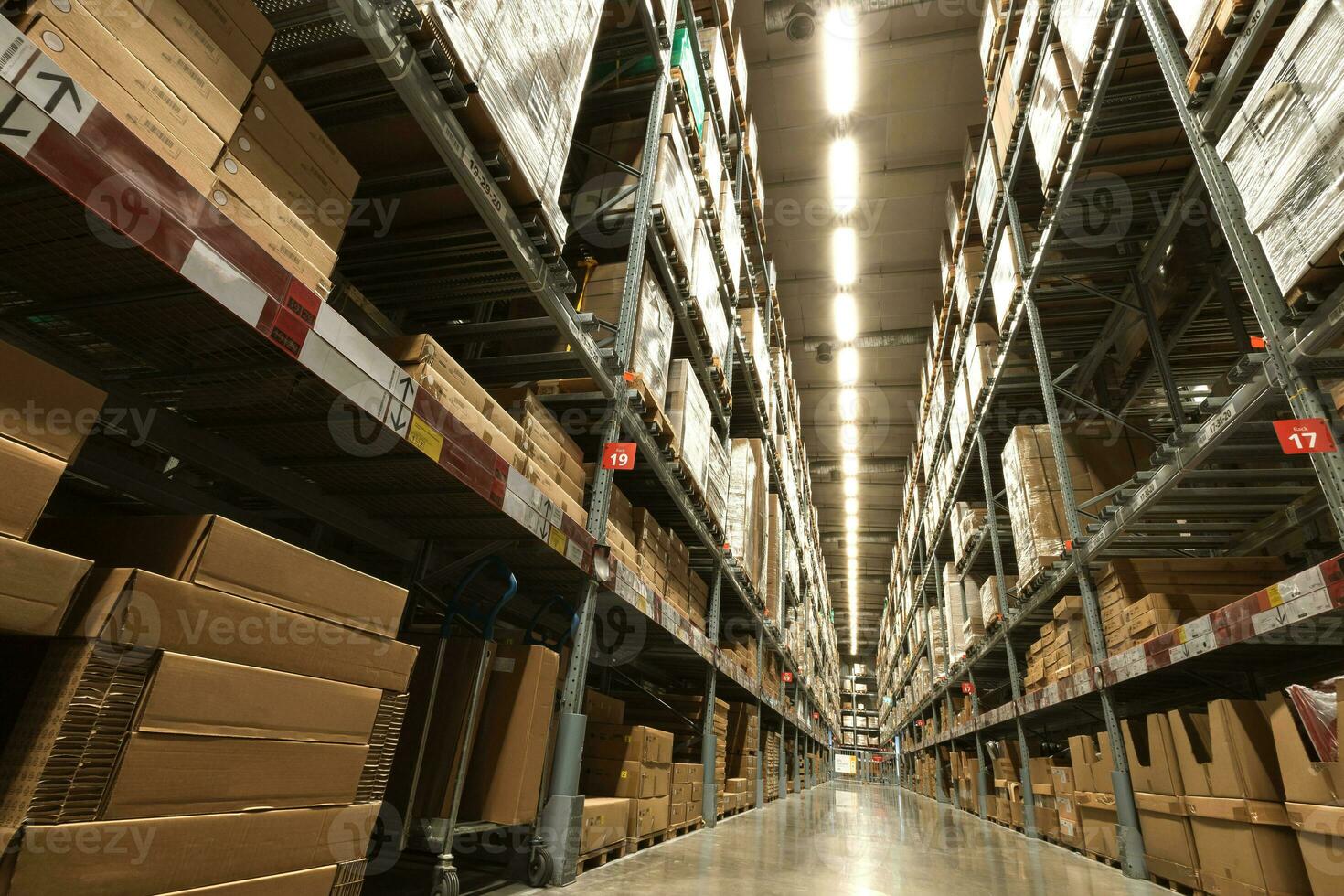 A large warehouse of furniture department stores. A warehouse where goods are stacked in record steel frames for replenishing stock of products sold to customers. photo