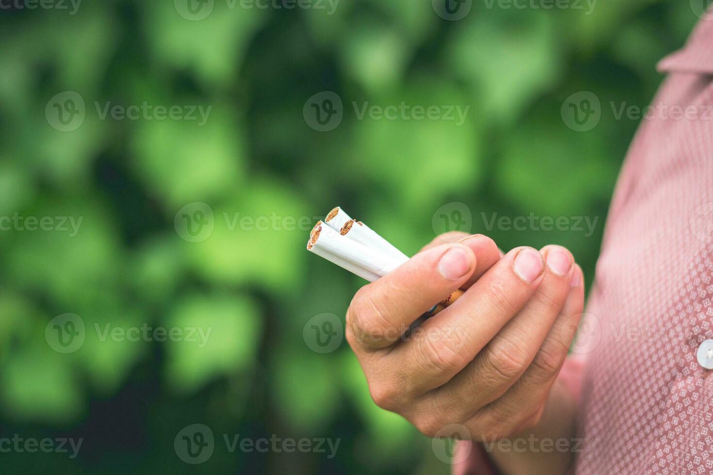 A smoker is holding some cigarette on the hand photo