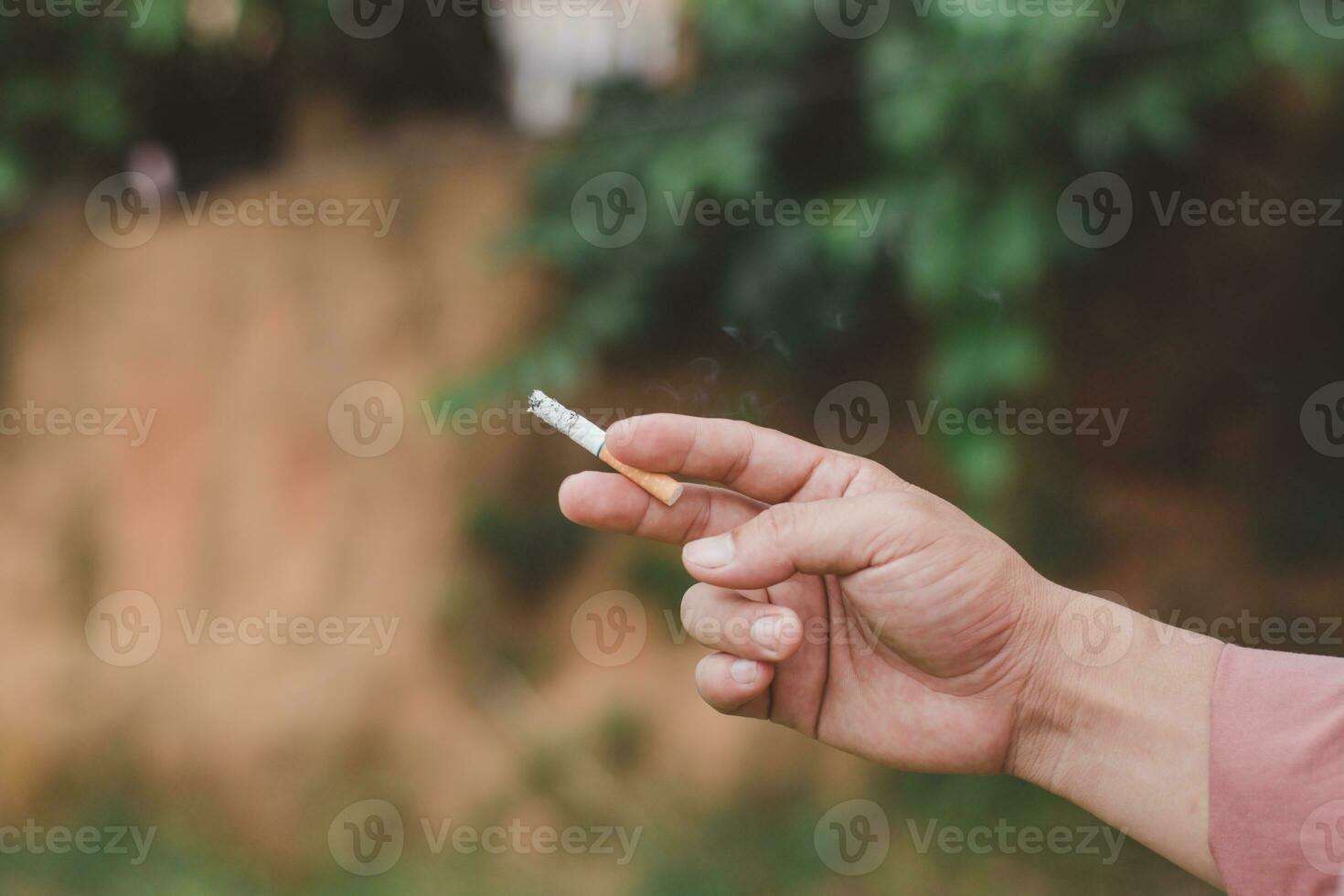 Hand holding cigarette photo