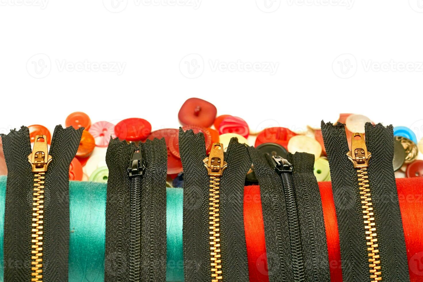 Black zippers for clothes,a spools of thread,buttons photo