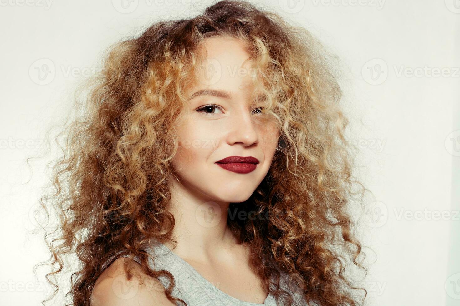 Beauty young woman with curly big and long hair. photo