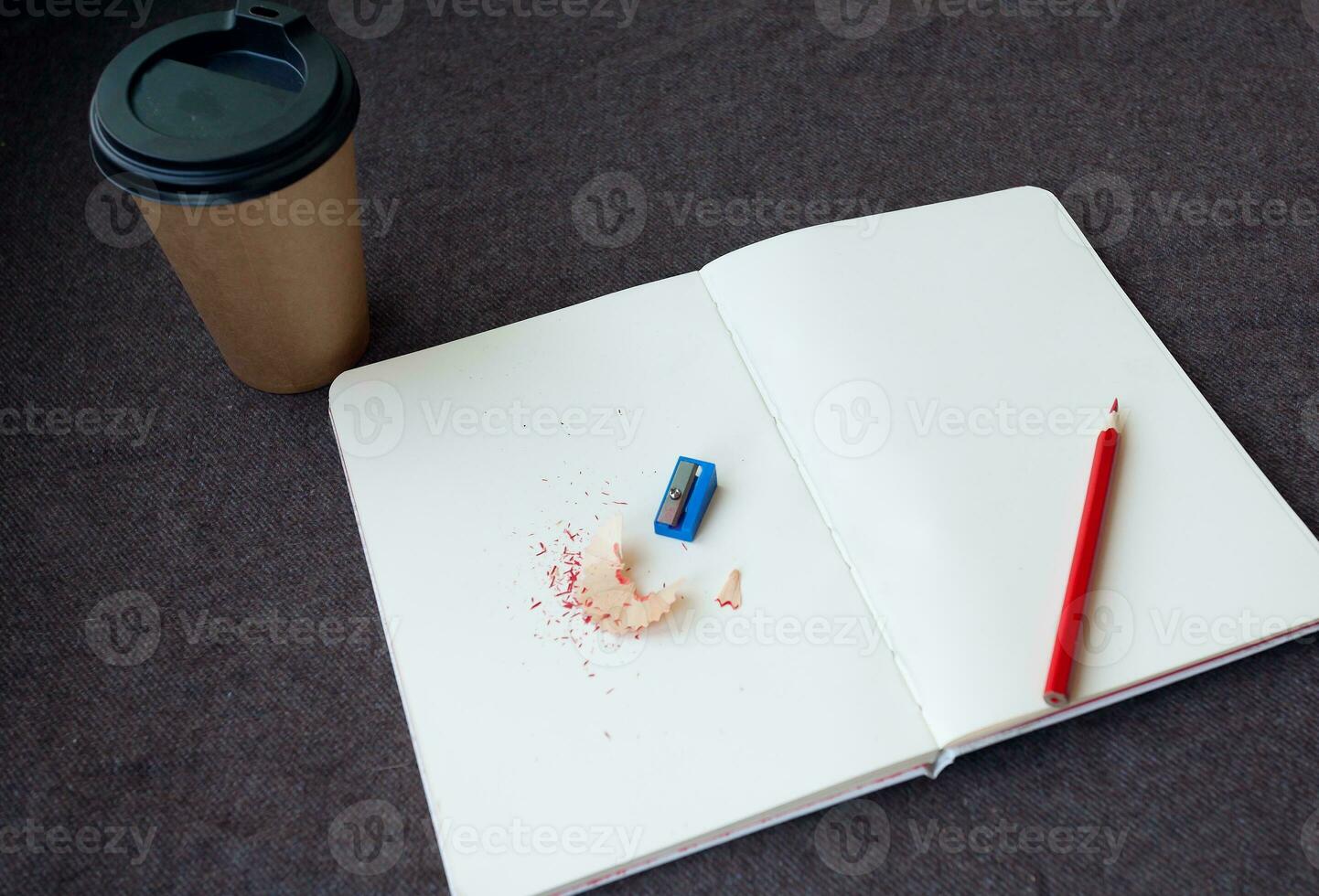 Pencil, notebook and paper coffee cup photo