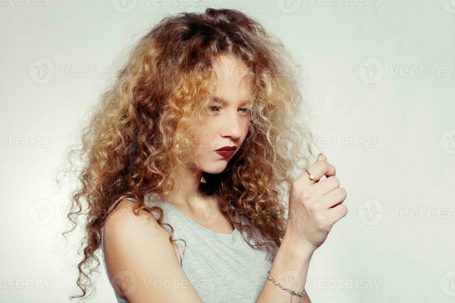 Beauty young woman with curly big and long hair. photo