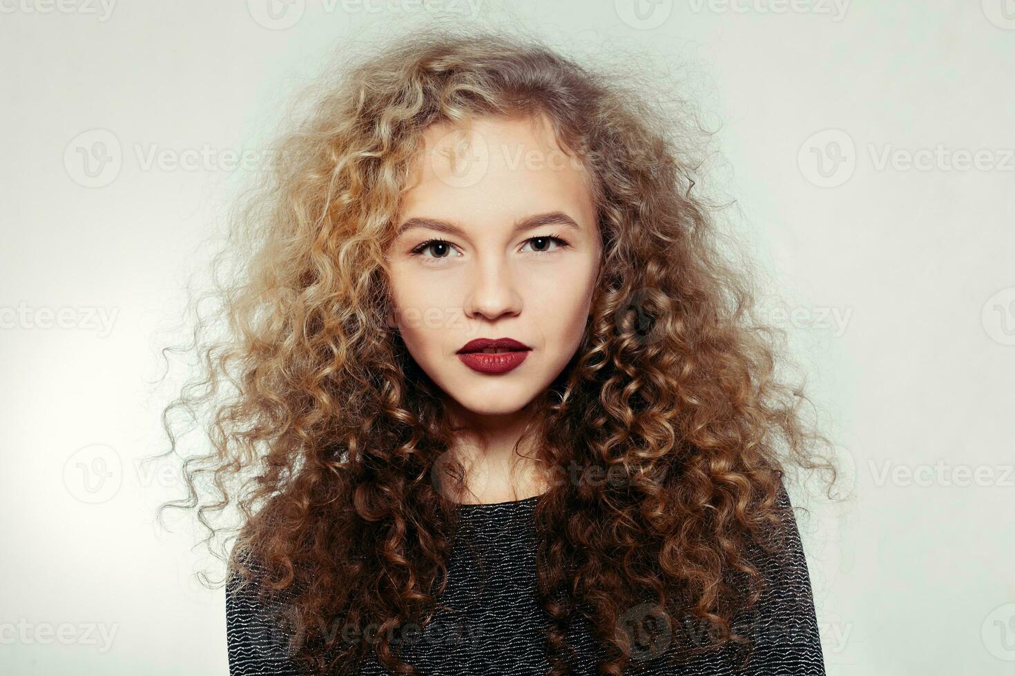 Beauty young woman with curly big and long hair. photo