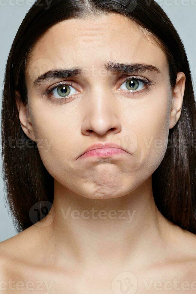 Portrait of young woman with shocked facial expression photo