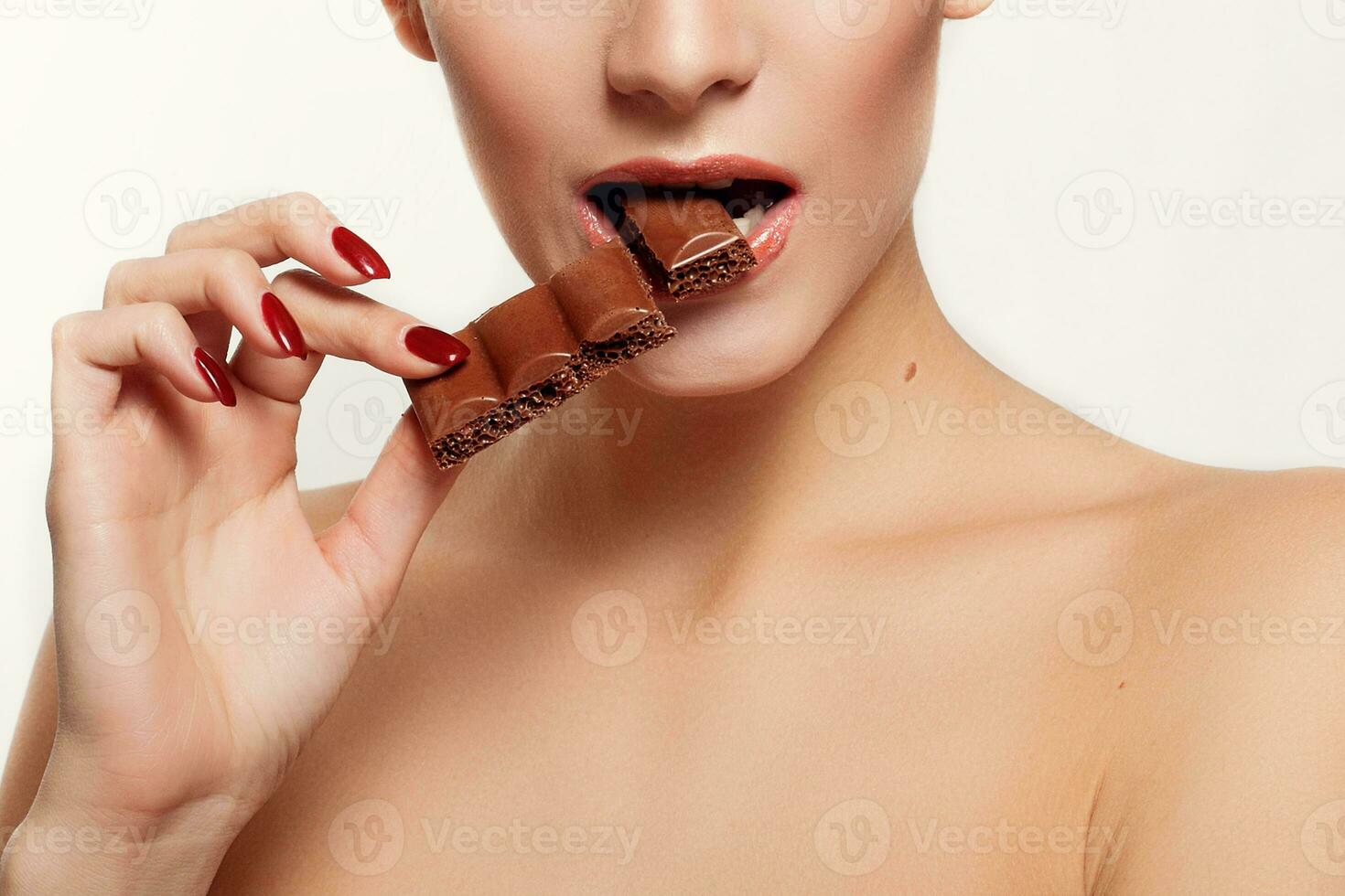 Lovely smiling teenage girl eating chocolate photo