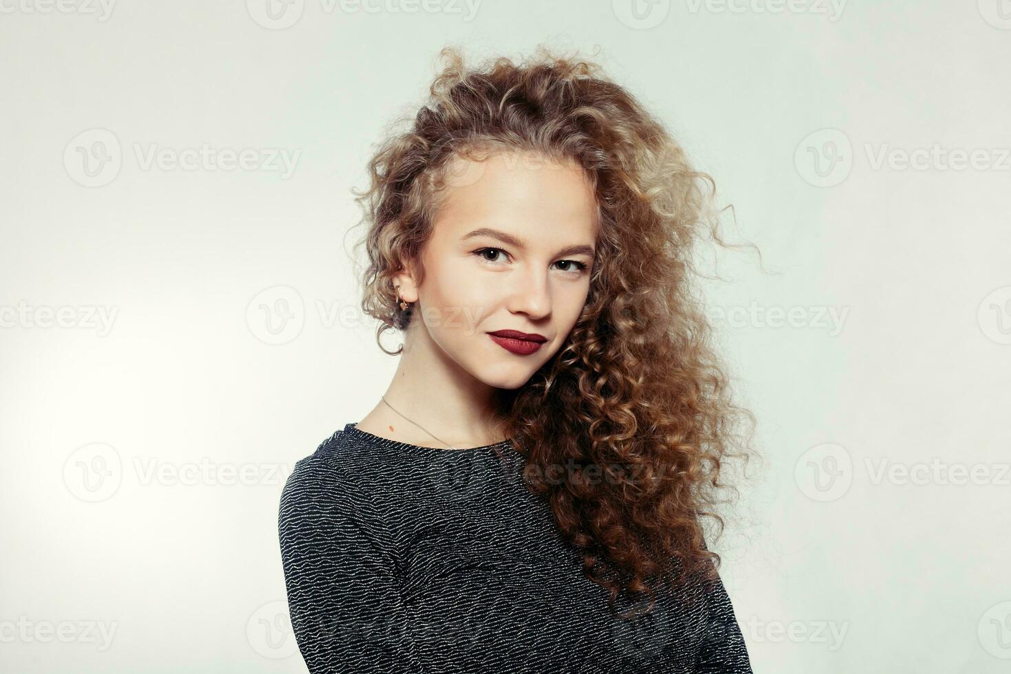 Beauty young woman with curly big and long hair. photo