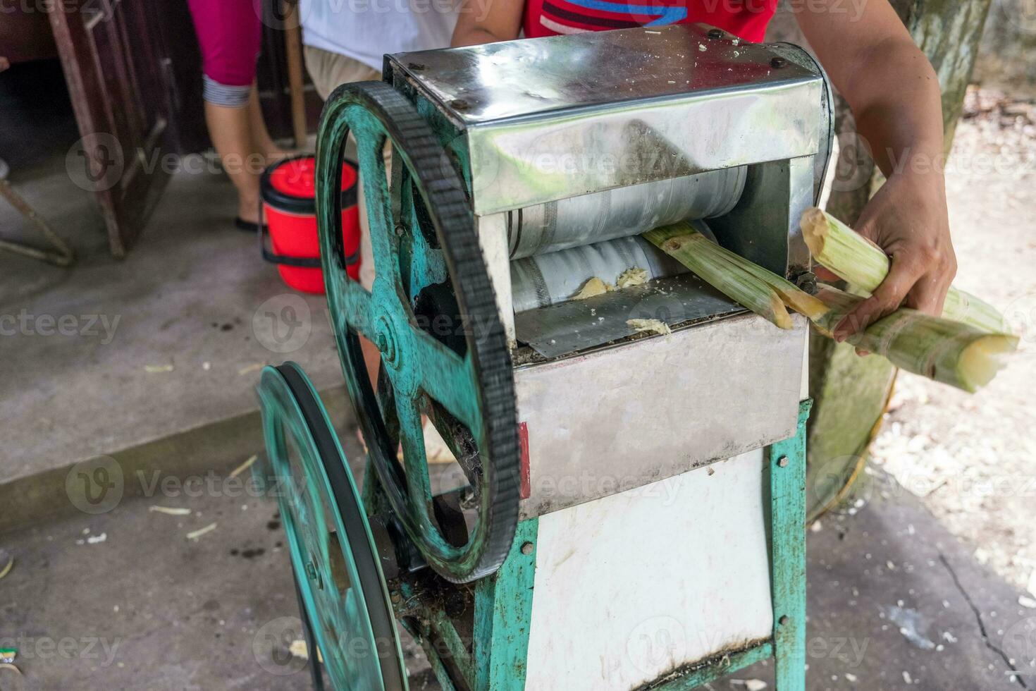 Crush machine working with crushed sugar cane in store photo