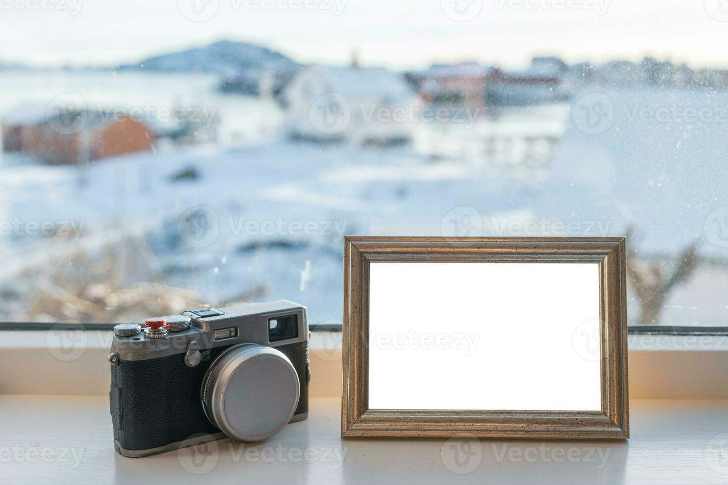 Vintage Camera with blank picture frame on window sill photo