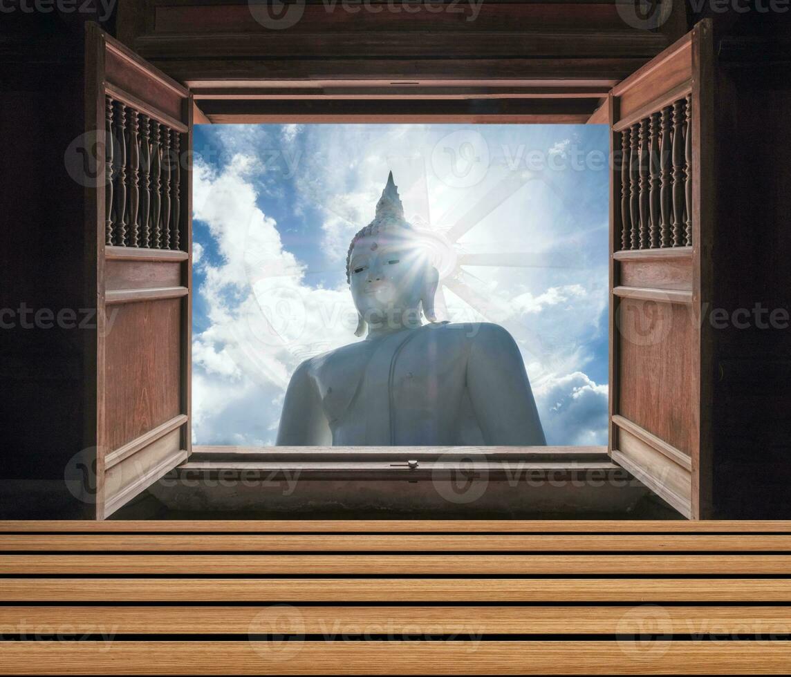 de madera ventana abierto con grande Buda estatua y vida rueda en cielo foto
