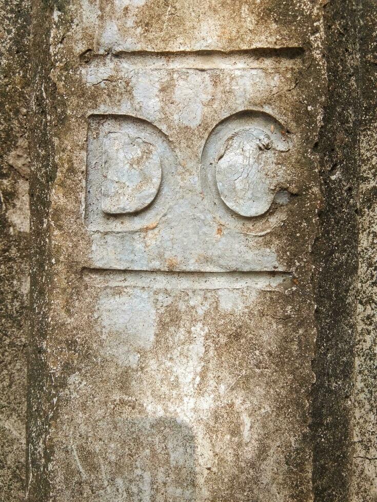 Old wall texture abrasion cement with capital letter D and C, vintage wall design photo