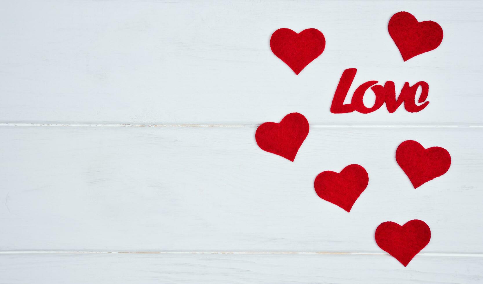 Red hearts and word Love on white wooden background. Valentine's Day holiday concept. Banner. Top view. Flatlay. Copy space. photo