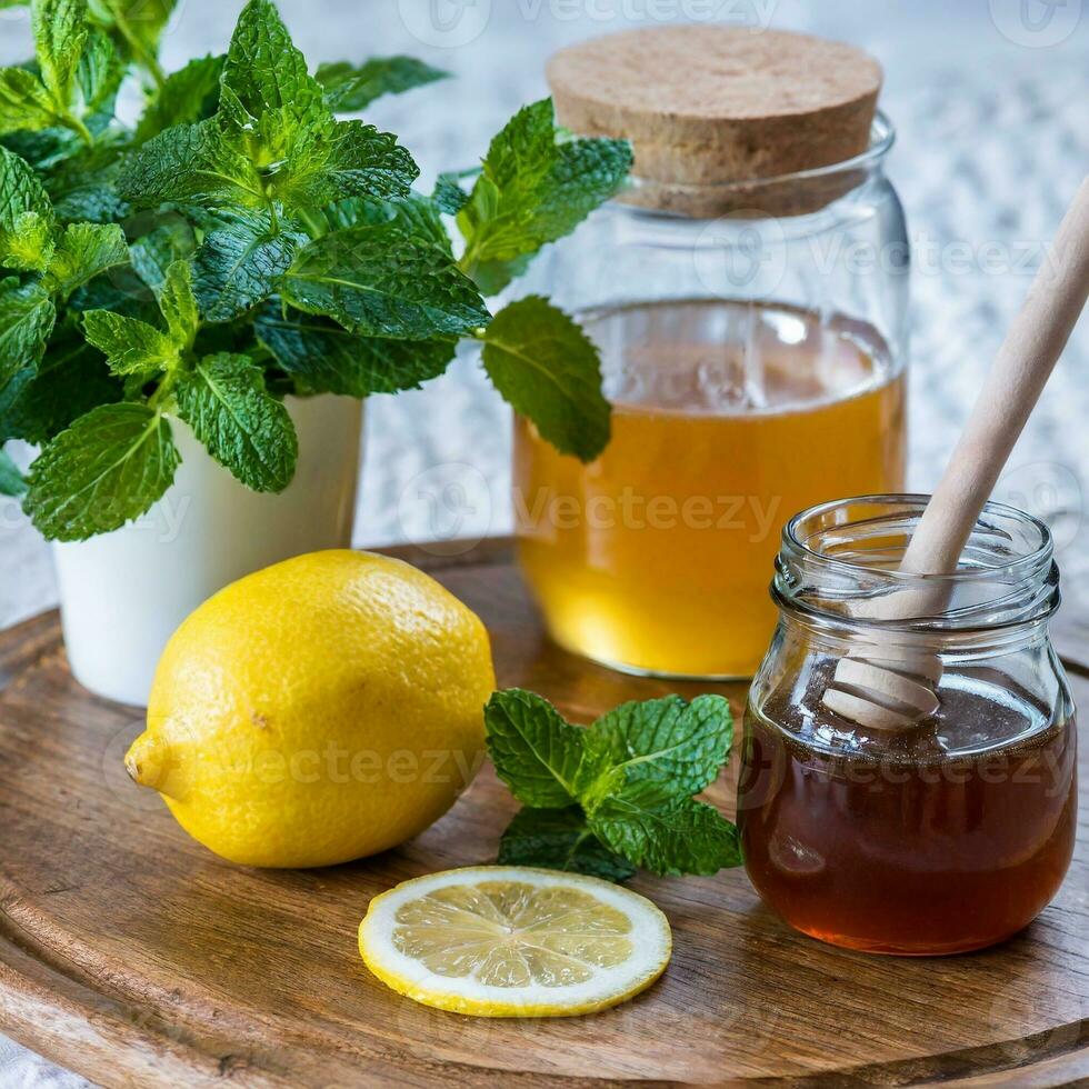 Honey in jar with honey dipper on vintage wooden background photo