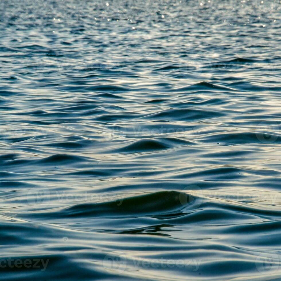 ocean water background abstract background of seawater flow under light exposure photo