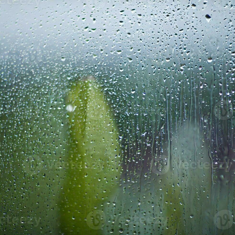 water drops on the glass wet window glass with splashes and drops of water photo