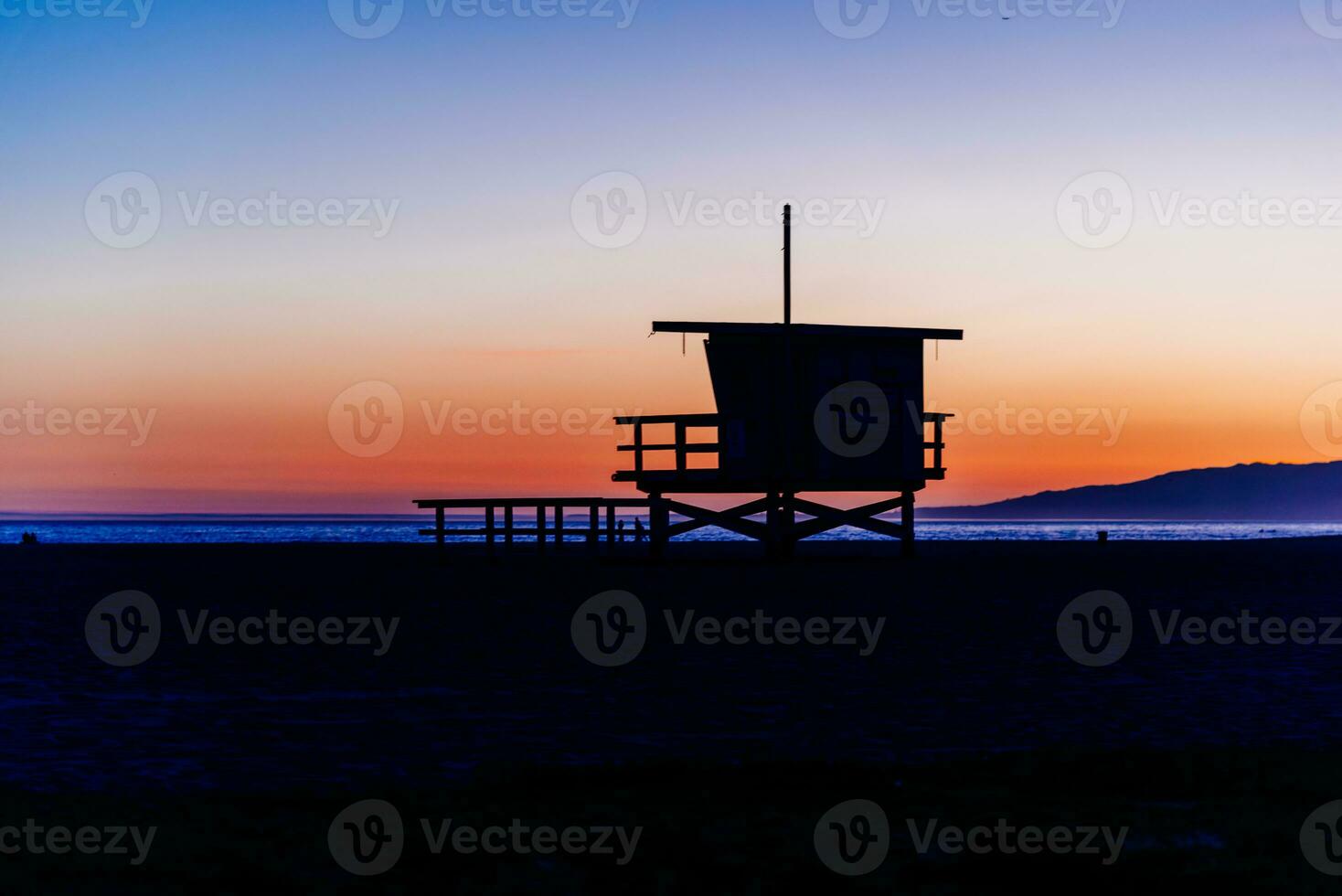 Sunset over Baywatch booths in California photo