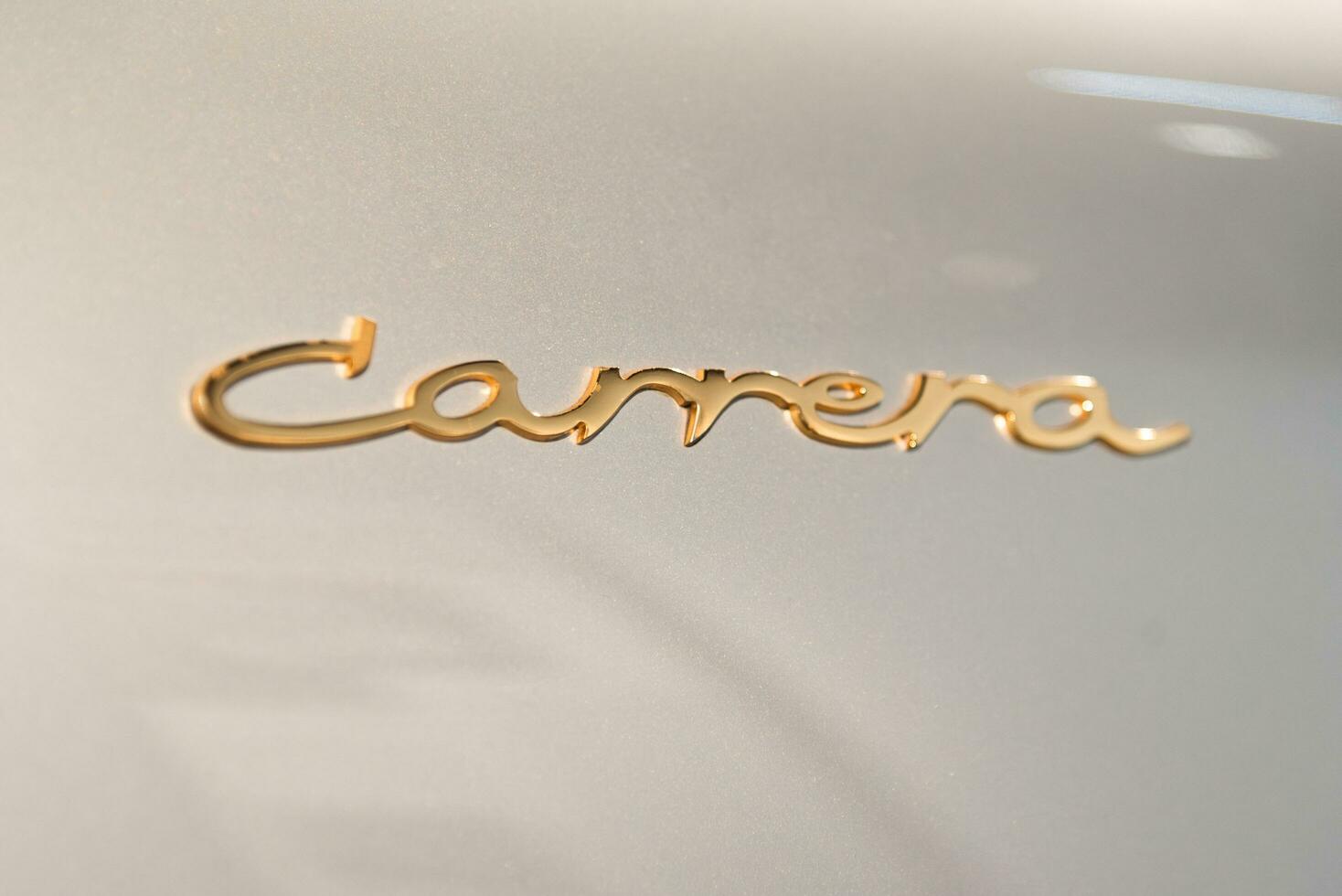 Los Angeles, CA - 16 Apr 2023 - Close up logo of Porsche Carrera on a grey metal photo