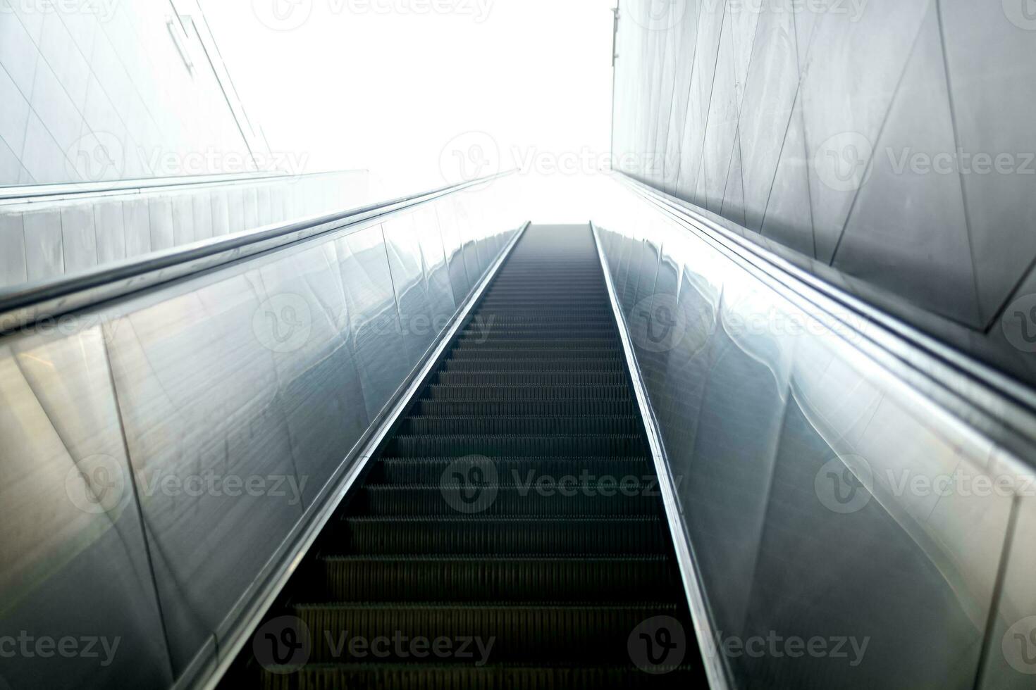 escalator leads somewhere to the light photo