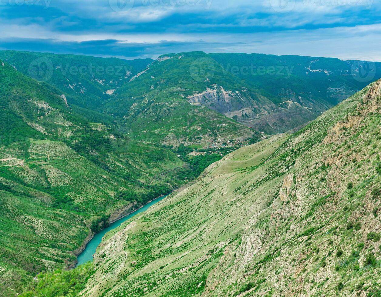 Mountain landscape in the Caucasus in Dagestan, view of the canyon of the Sulak River with the village of Old Zubutli in the distance on the slope photo