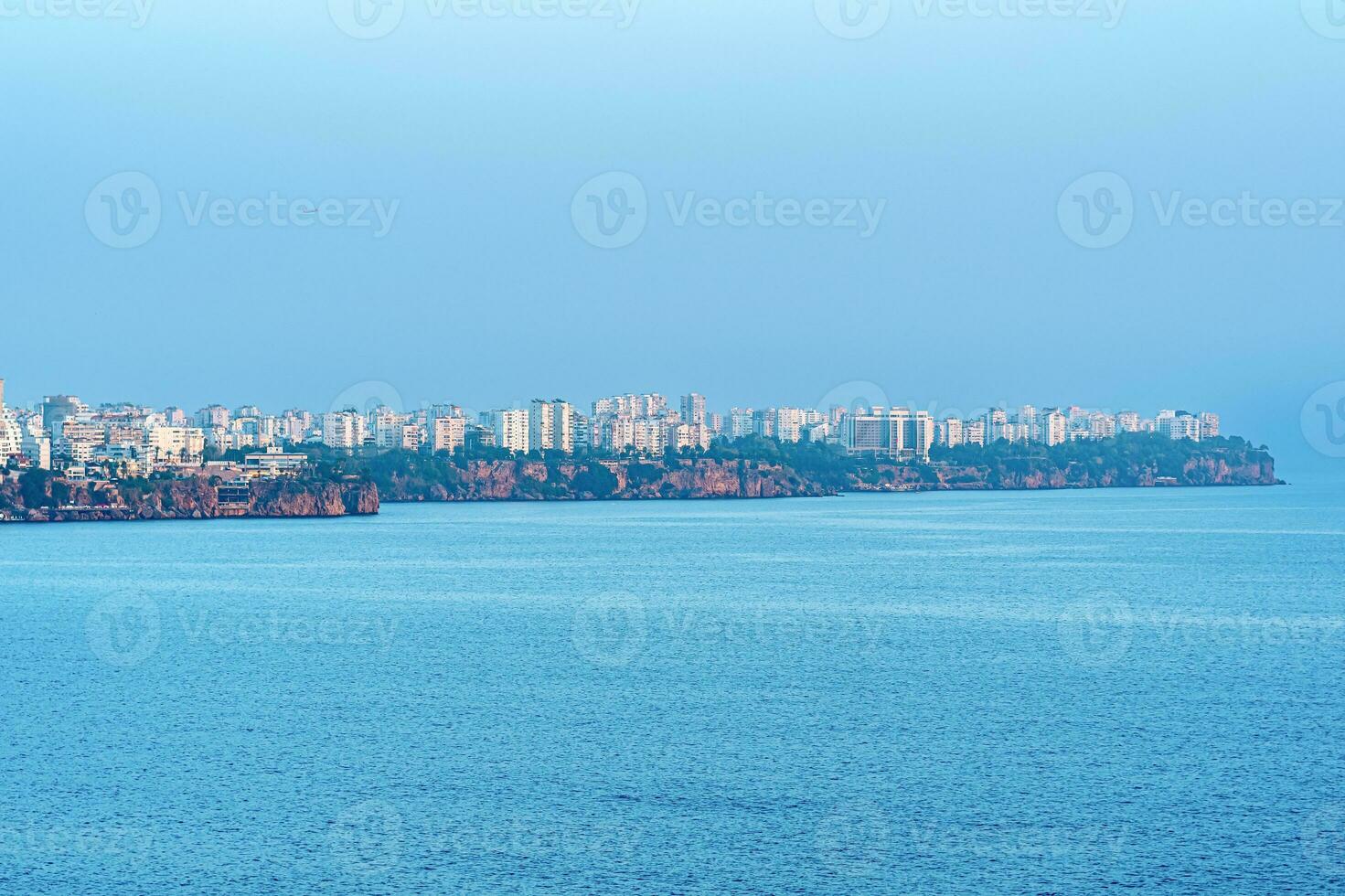 view from the sea on the coast of Antalya in a blue haze photo