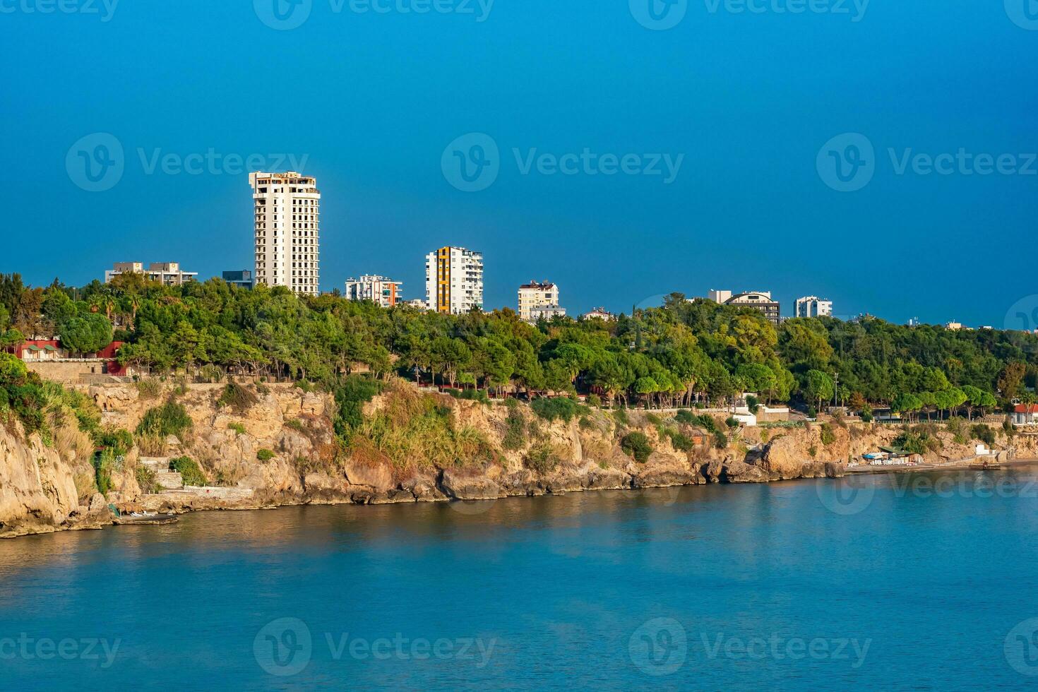 view of the high coast of the city of Antalya from the sea photo