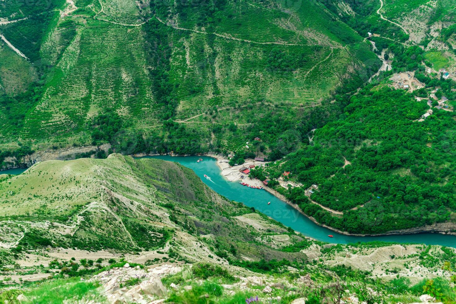 top view of the mountain river Sulak in Dagestan with a tourist boat base photo