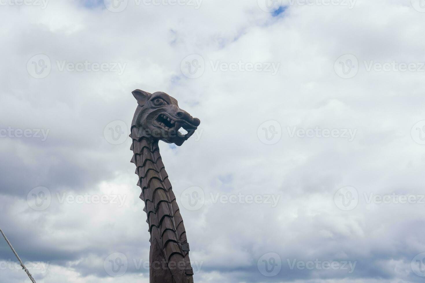 figurehead on the bow of a full-scale replica of a viking ship, against a sky photo