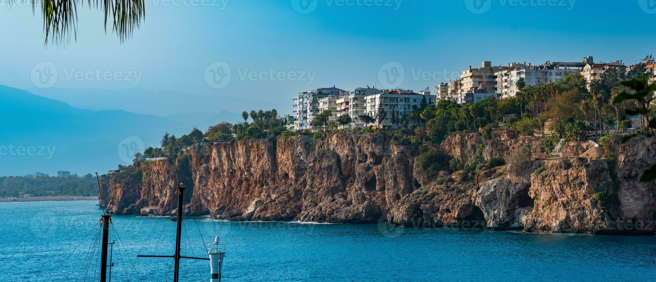 seascape with residential buildings and hotels on the steep coast of Antalya, Turkey photo