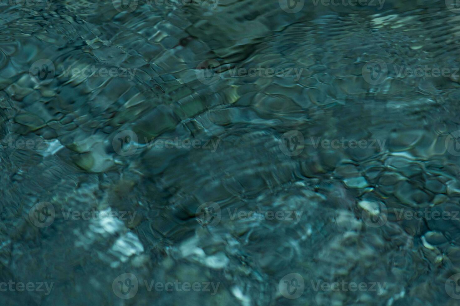 abstract blurred background - the surface of a transparent clean reservoir with circles from drops photo