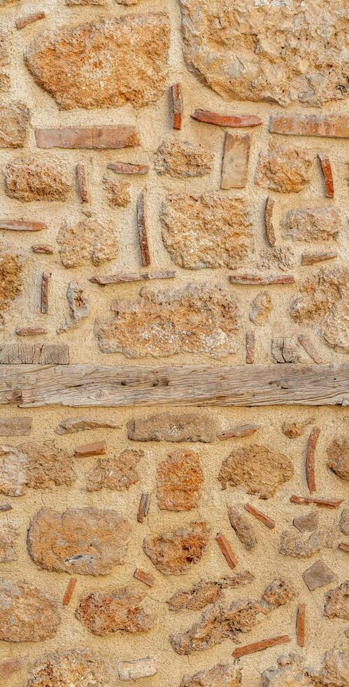 background, texture - rough masonry from wild stone and cement on a wooden frame photo