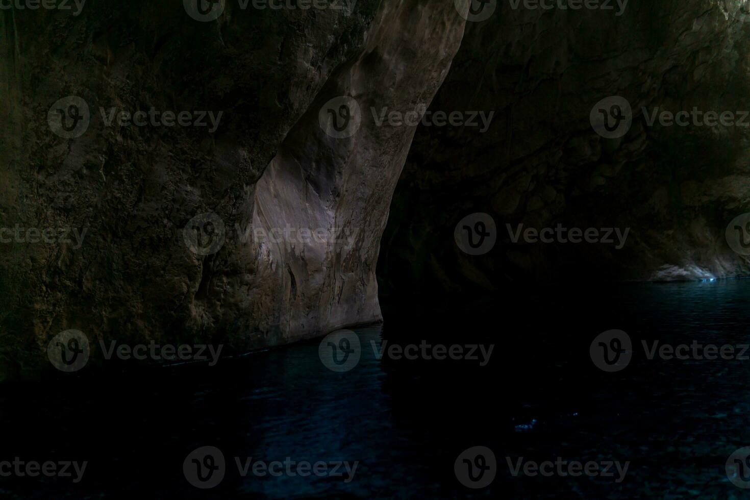 clean underground cave river in steep stone banks in the dark photo