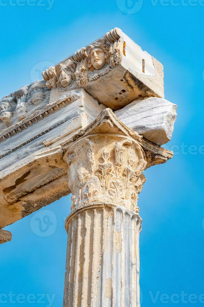 fragment of the colonnade of the destroyed temple of Apollo from Side with a stone-cut relief on the frieze photo