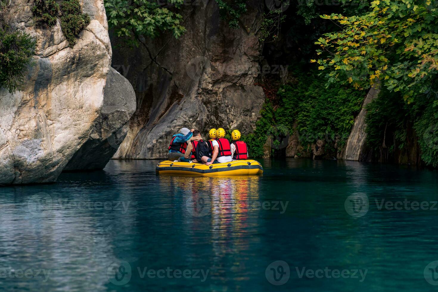 tourists on an inflatable boat rafting down the blue water canyon in Goynuk, Turkey photo