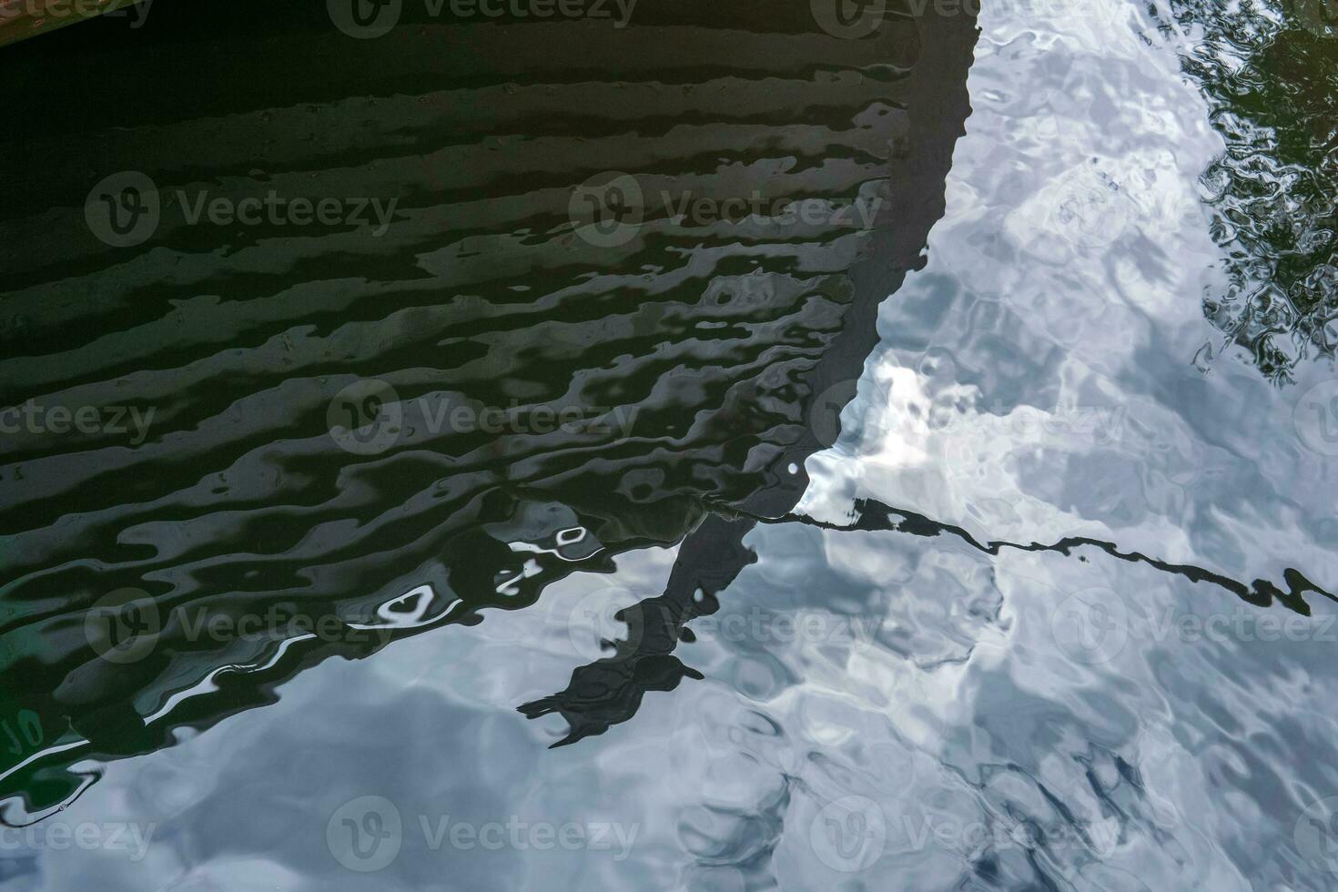 reflection in the water of the bow of an ancient viking ship photo