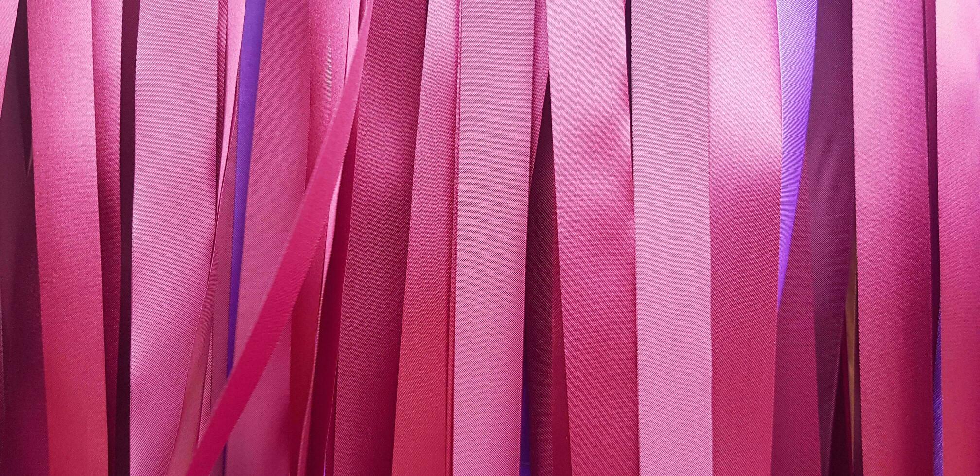 Purple or violet, pink or red ribbon background or wall. Pastel and colorful paper or fabric decoration in party, festival, wedding, New year and celebration concept. photo