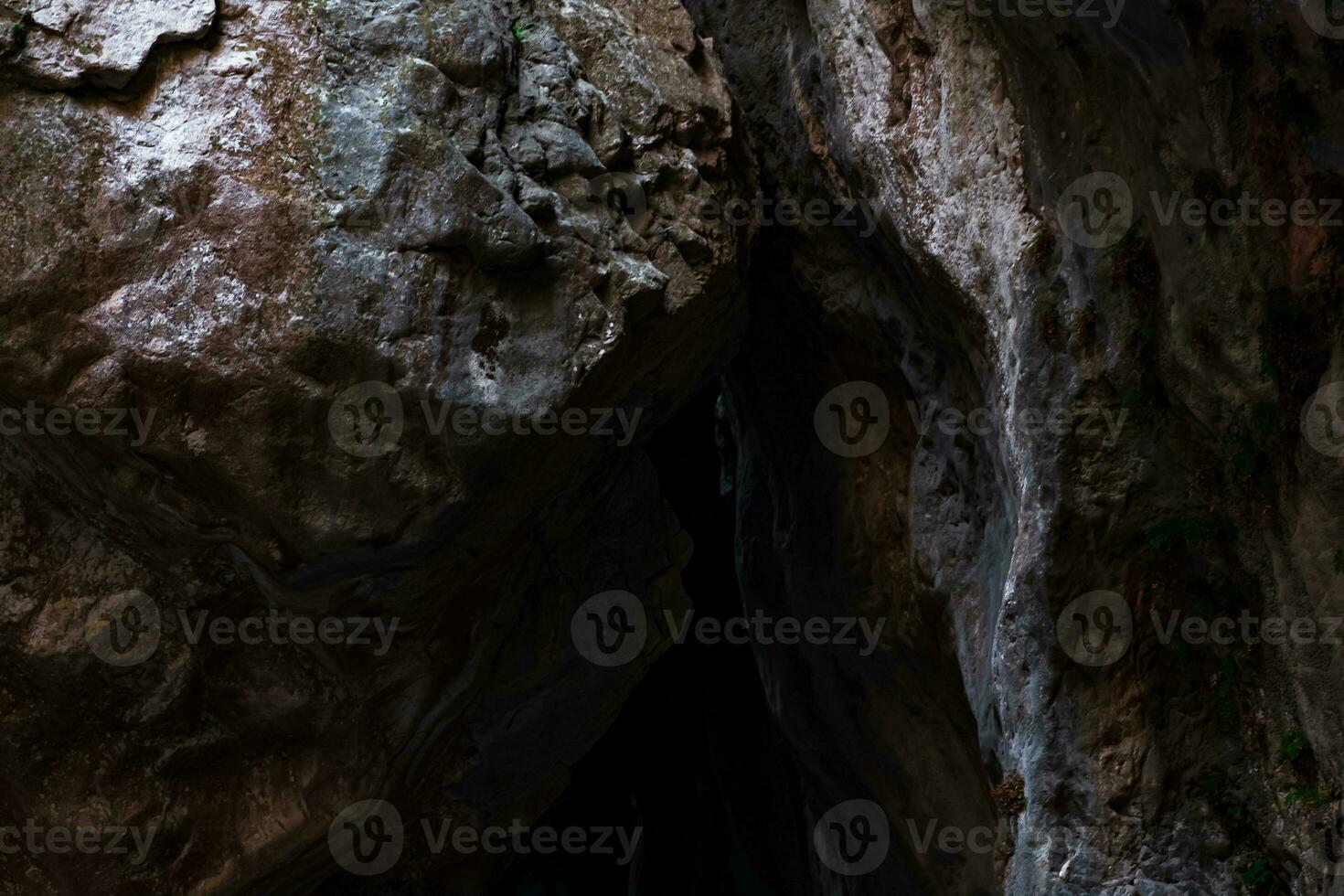 walls of a narrow canyon close, forming the vaults of the cave photo